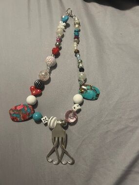 Beautiful necklace featuring a fork, and stones
